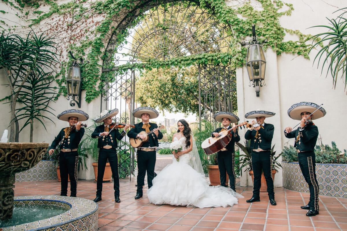 mexican bride standing with a mariachi band