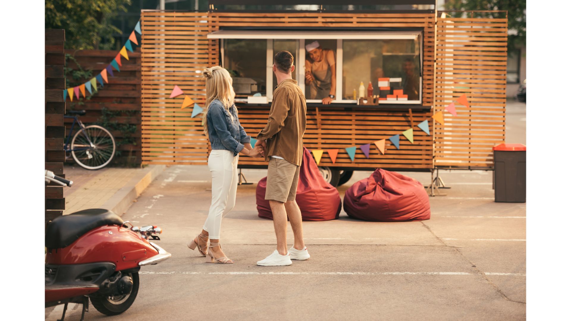 side view of couple holding hands near food truck