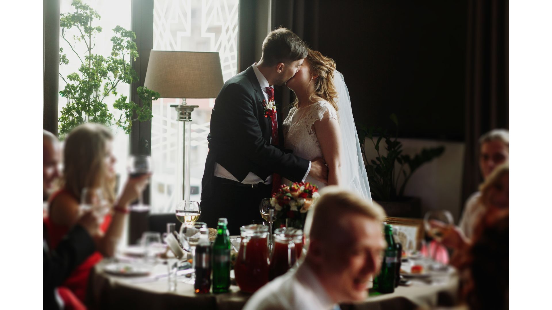 newlywed couple kissing at wedding