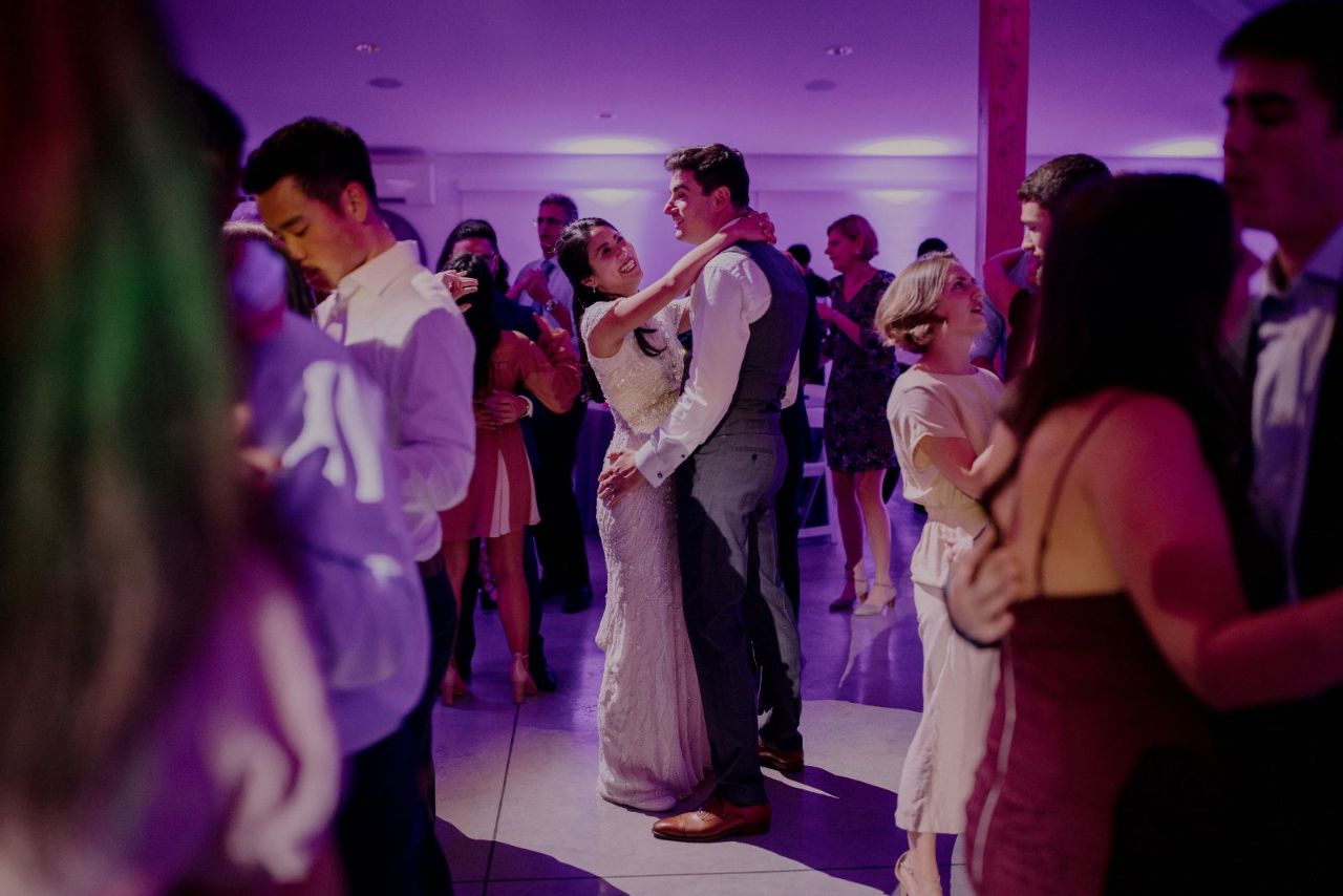 couple dancing at a wedding with lighting