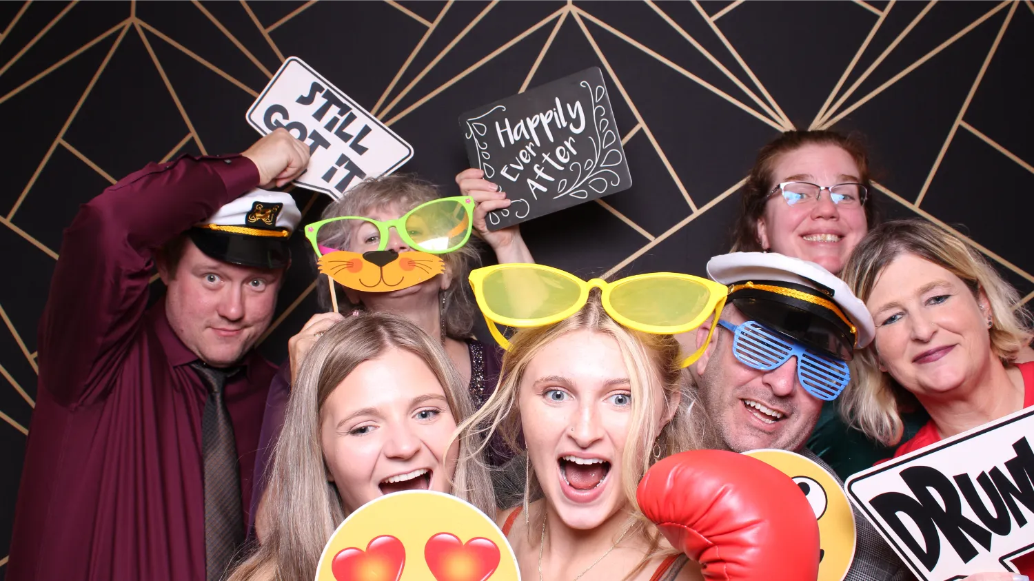 A group of people wearing funny glasses and holding signs.