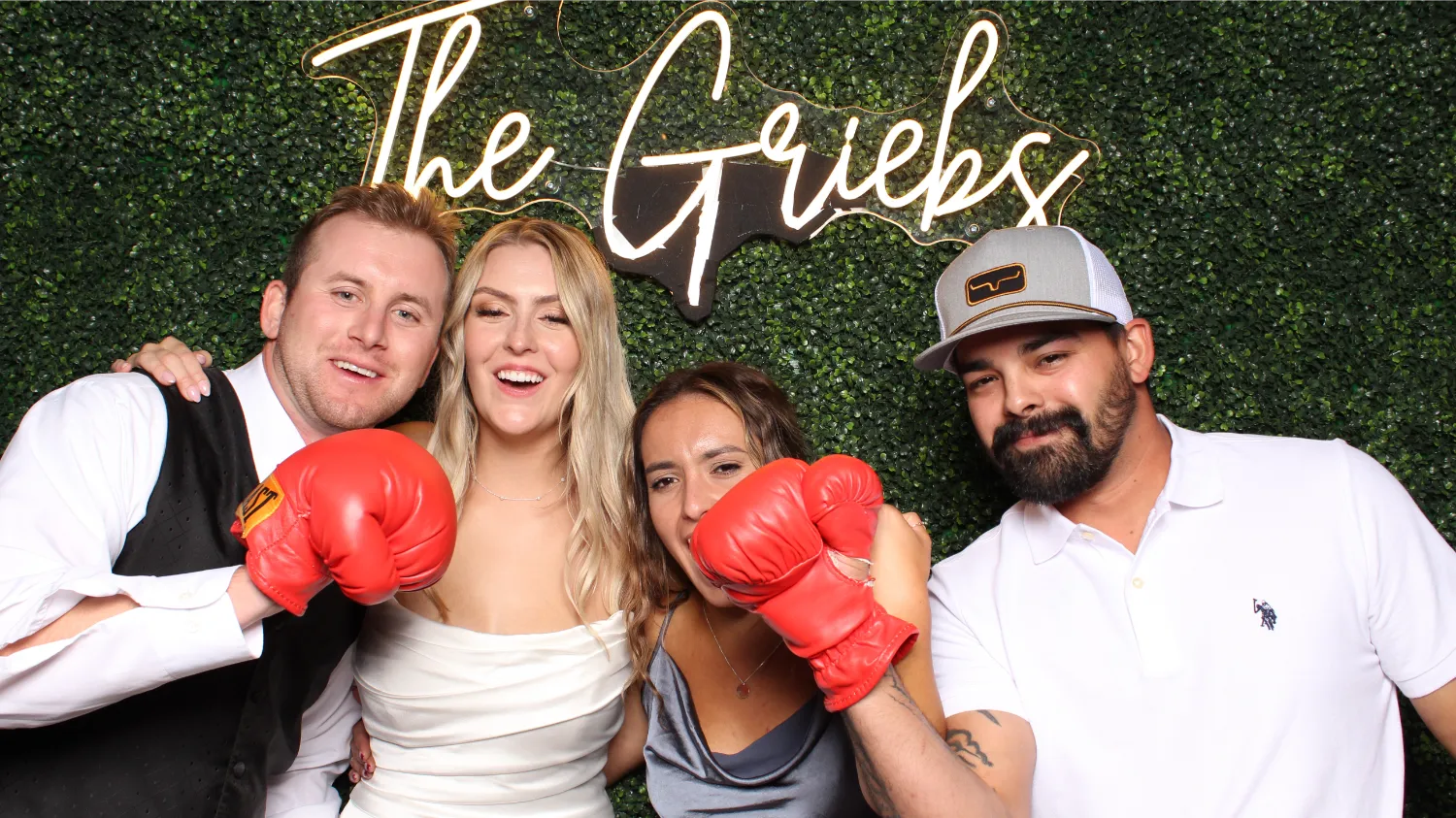 Three people posing for a picture with boxing gloves on.