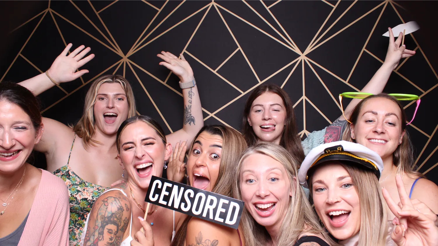 A group of women with tattoos and one wearing a sailor hat.
