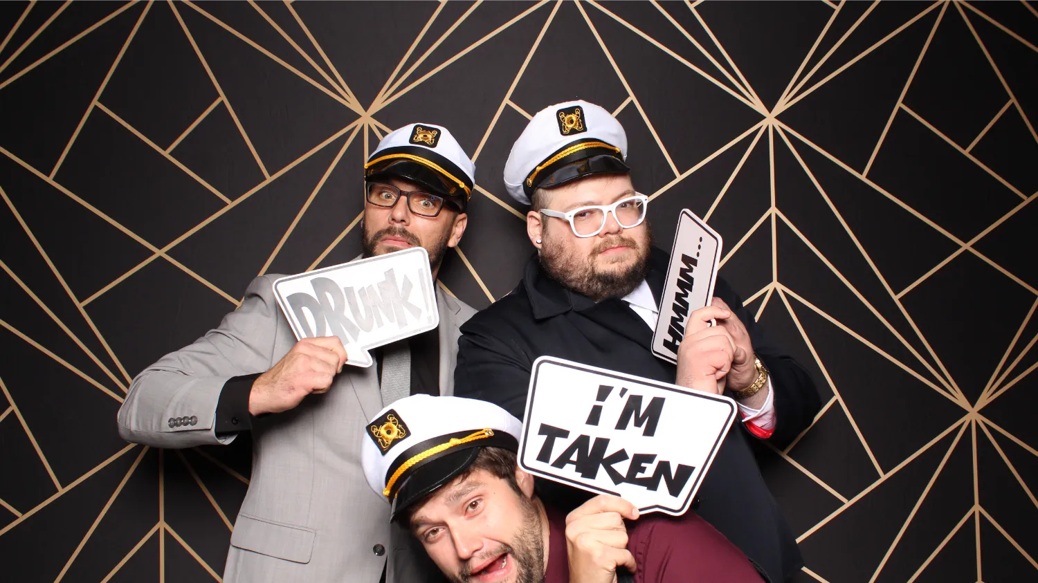 Three men wearing hats and holding signs that say "I'm taken".