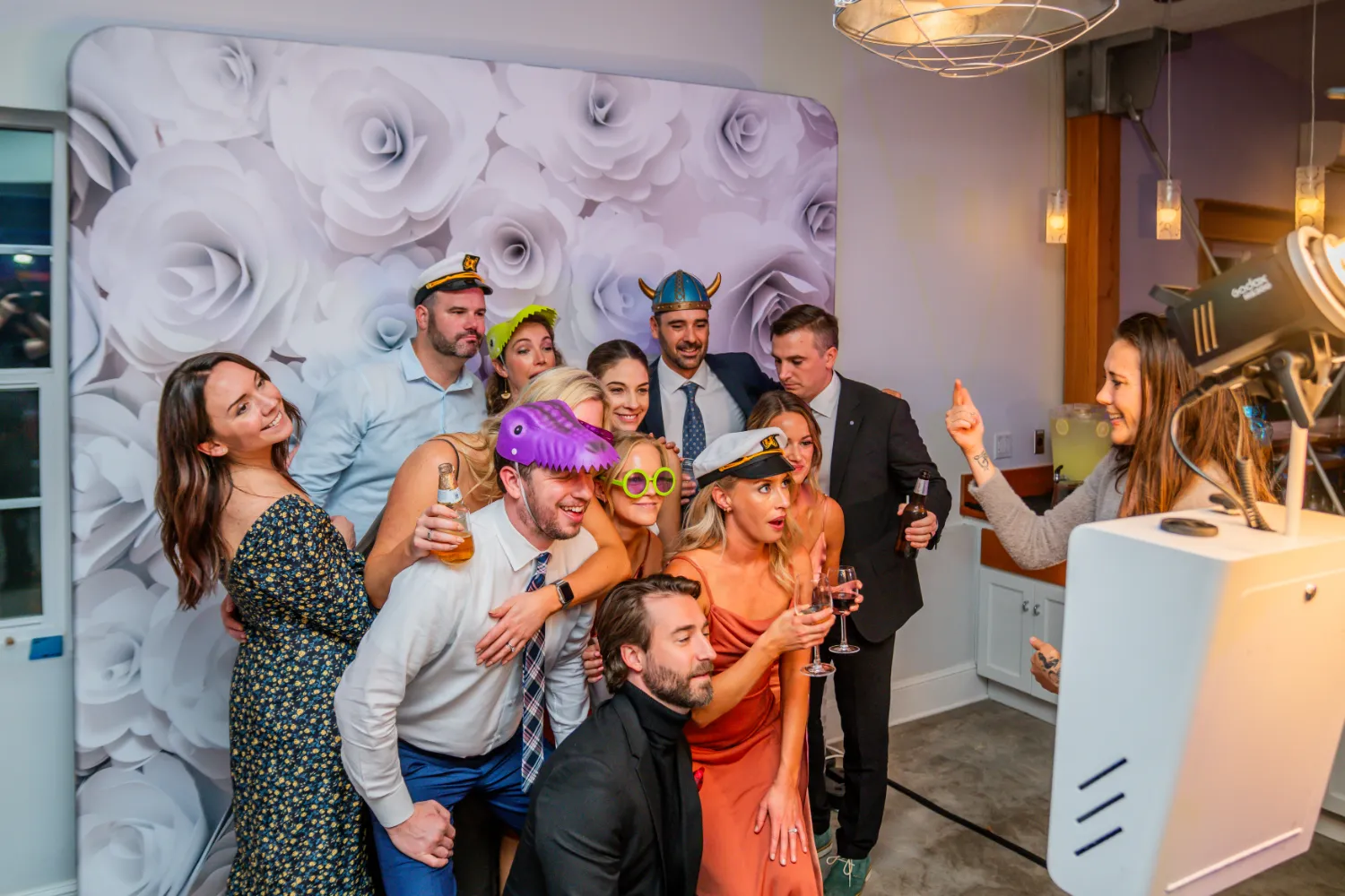 A group of people wearing funny hats and glasses pose for a picture.