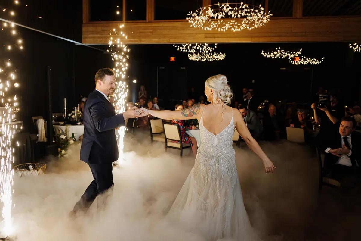 A man and woman are dancing in a cloud of smoke.