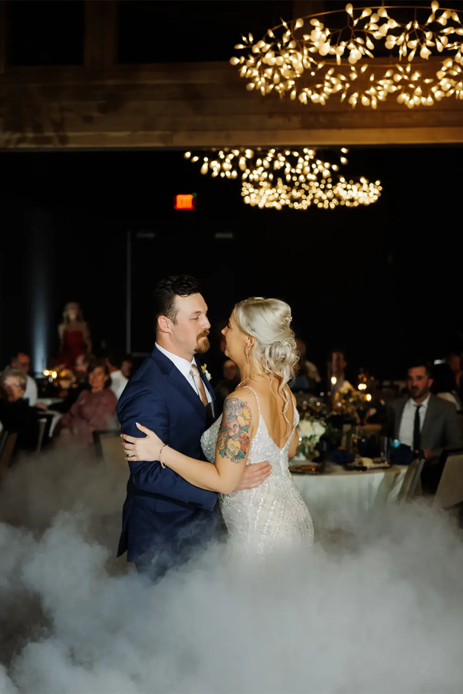 A man and woman dance in a hazy room.