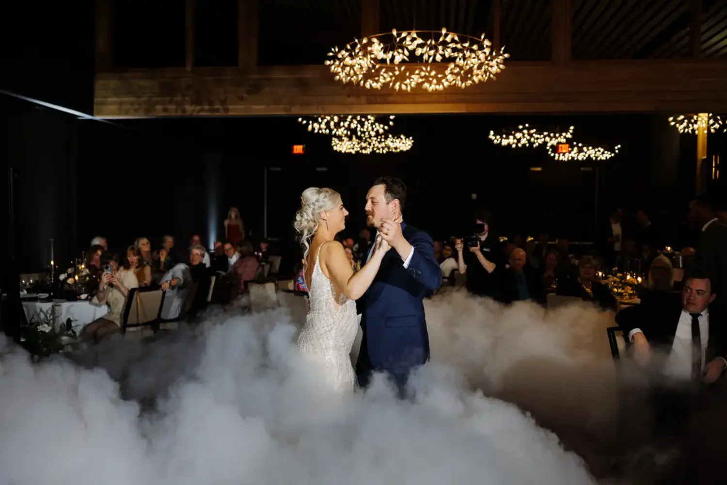 A man and woman dancing in a cloud of smoke.