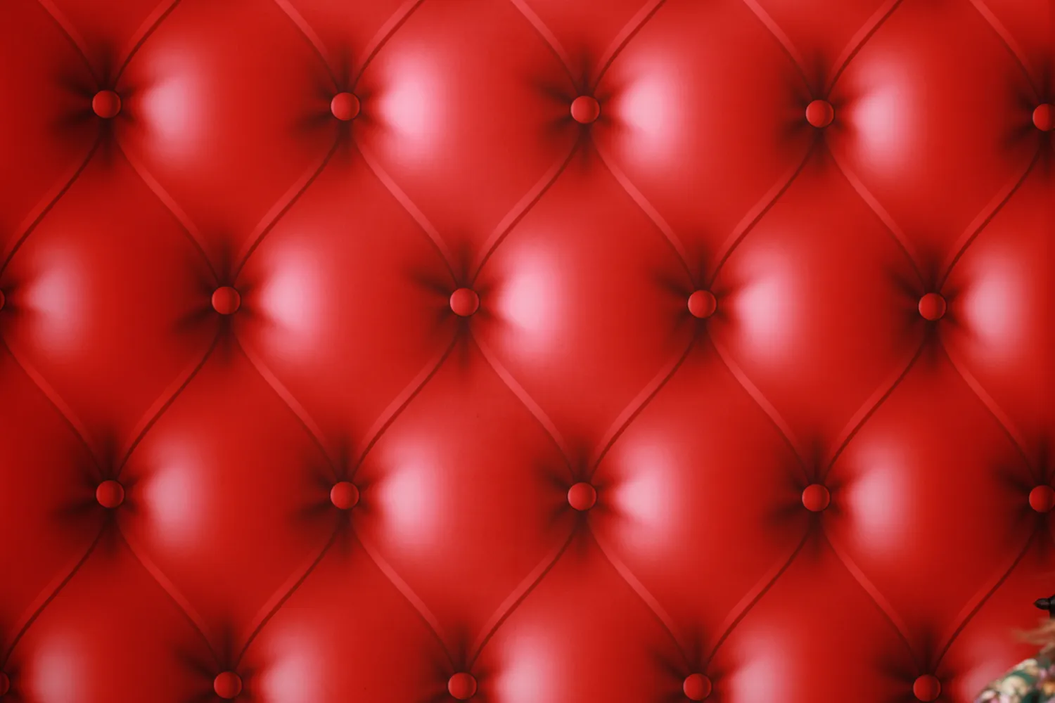 Luxurious red leather upholstery with tufted buttons and diamond pattern
