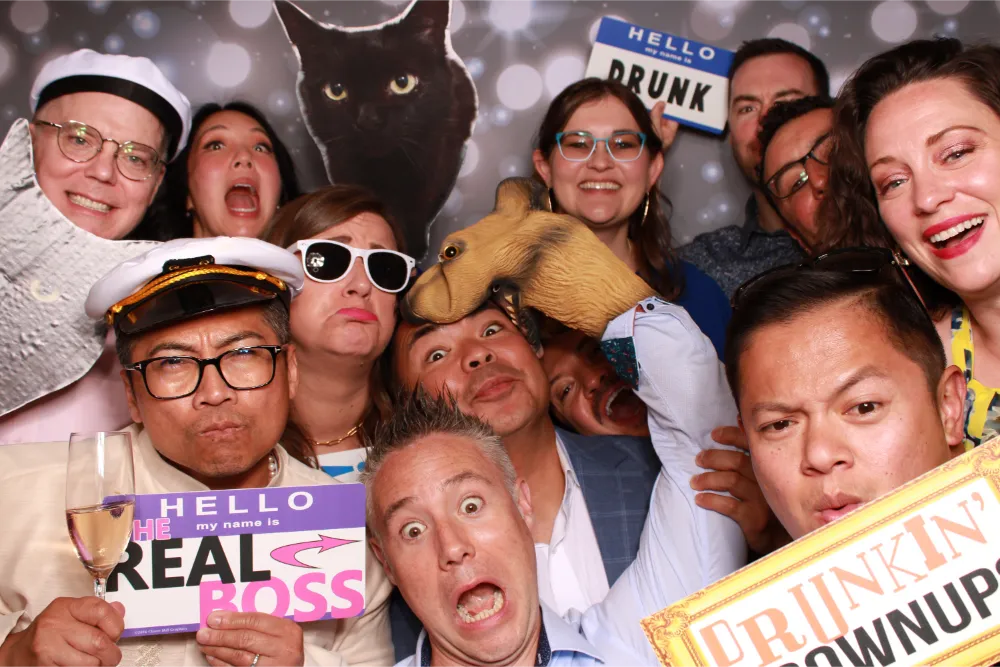 Funny photo booth with people wearing costumes and silly name tags