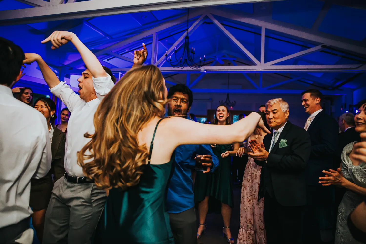 Energetic dance floor at a party with people dancing and celebrating