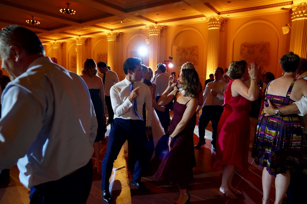 Wedding reception dance floor with guests dancing in elegant ballroom