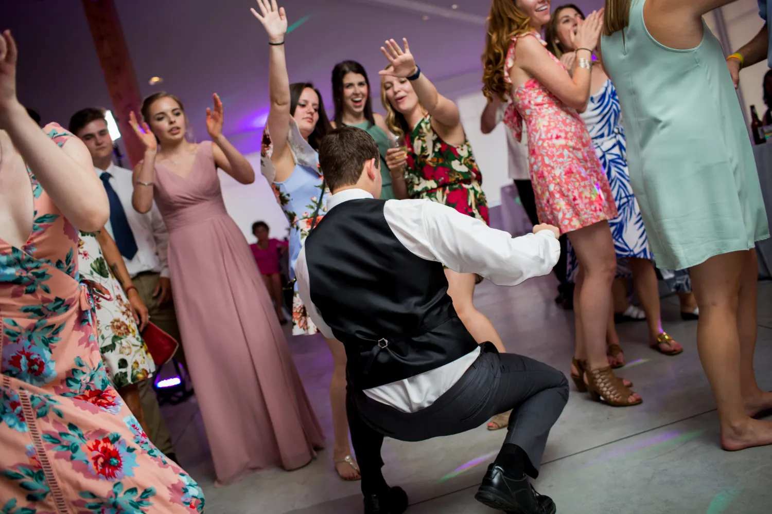 People dancing and celebrating at a festive event with colorful dresses