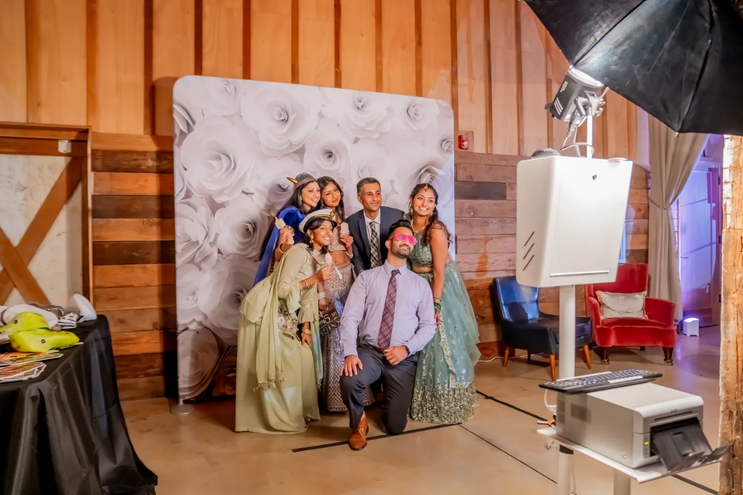 Group photo with elegant dresses in photography studio with floral backdrop