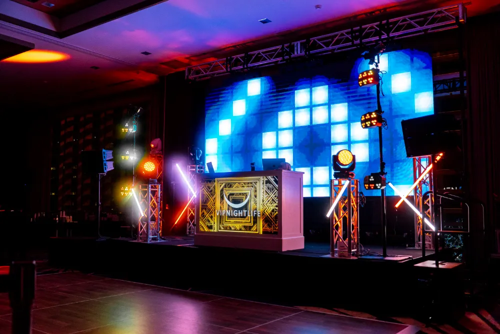 Nightlife event stage with colorful lighting and DJ setup