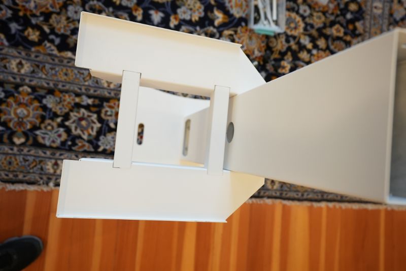 White geometric lamp or light fixture with angular design on patterned background