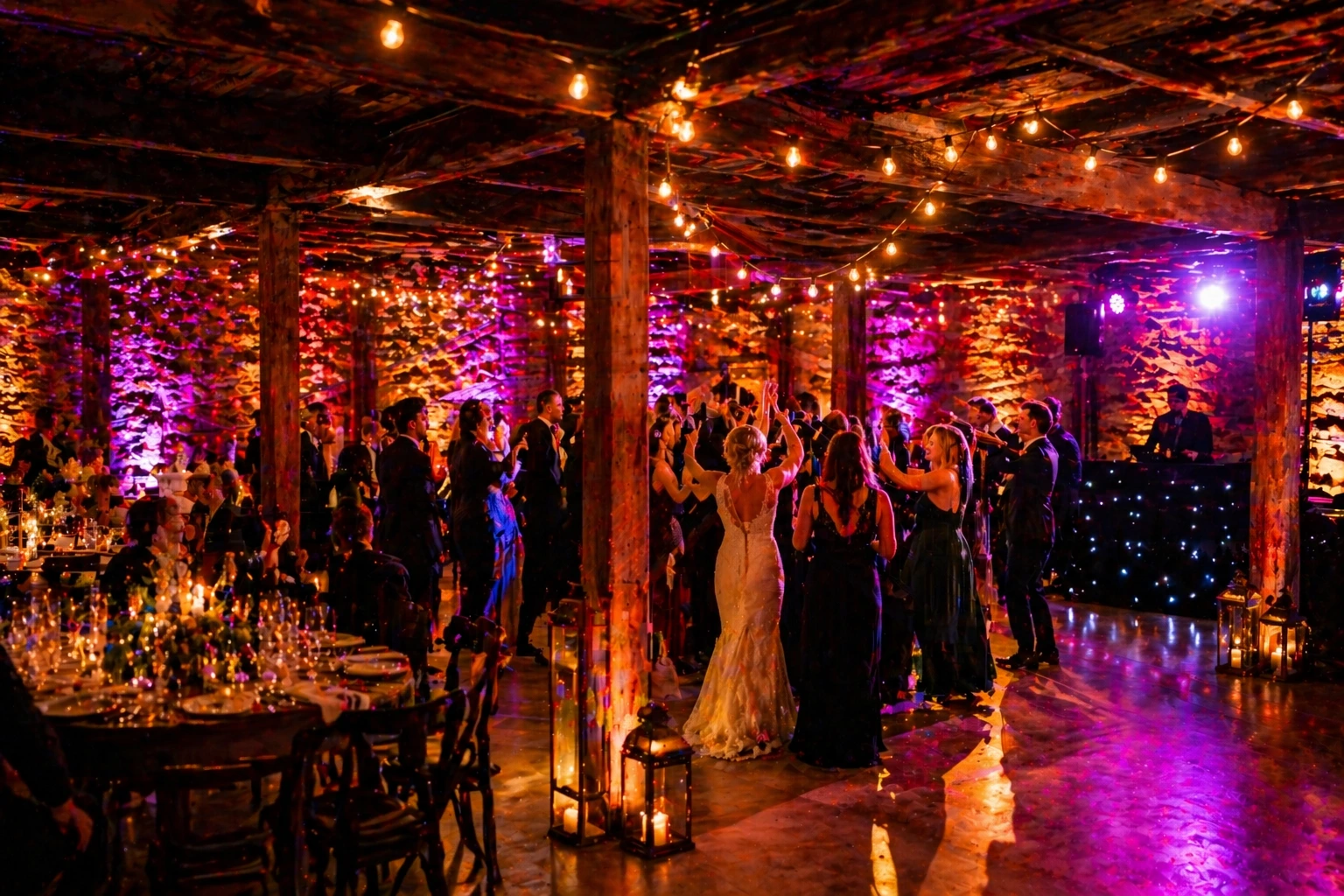 Crag Rat Hut basement dance floor at one of the top Hood River wedding venues transformed with warm uplighting and string lights for a wedding reception