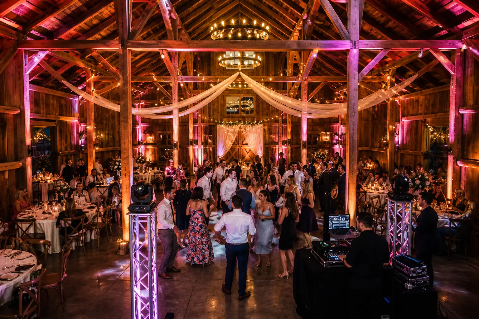 The Barn at Countryside Aurora Oregon wedding reception transformed with warm uplighting dance floor and rustic barn interior at night