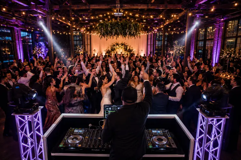 Wedding DJ value comparison showing Oregon professional sound system event lighting and packed dance floor representing return on investment in quality DJ services 