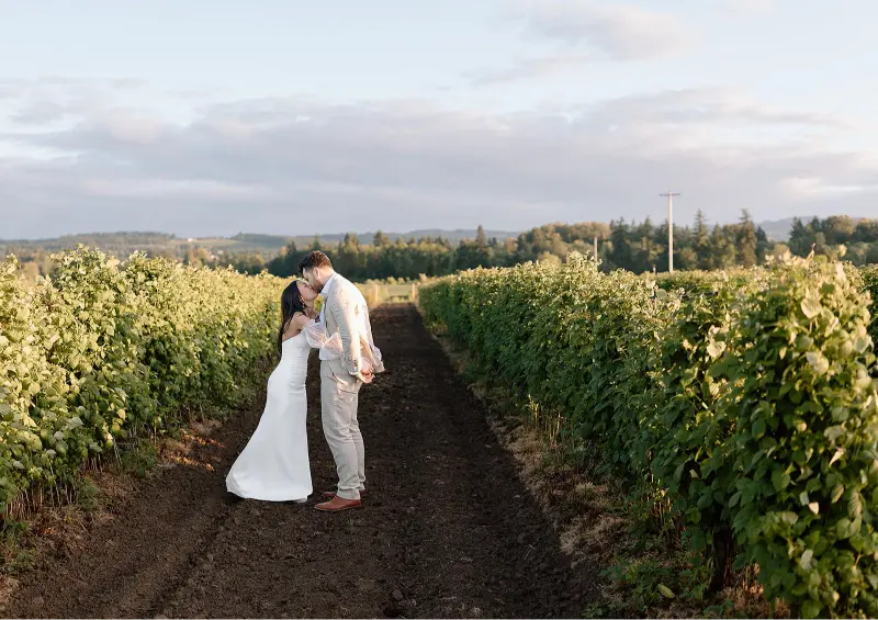 Bride and groom, Savanna and Angler, celebrating their wedding at Butler Barn, surrounded by the venue's rustic charm and scenic countryside.