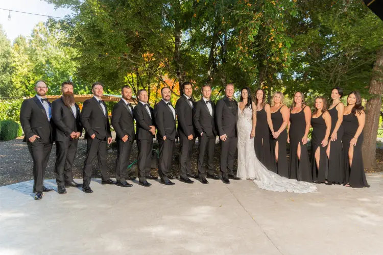 Bride, groom, bridesmaids, and groomsmen posing for an outdoor wedding party portrait at Water Oasis in Newberg, Oregon.