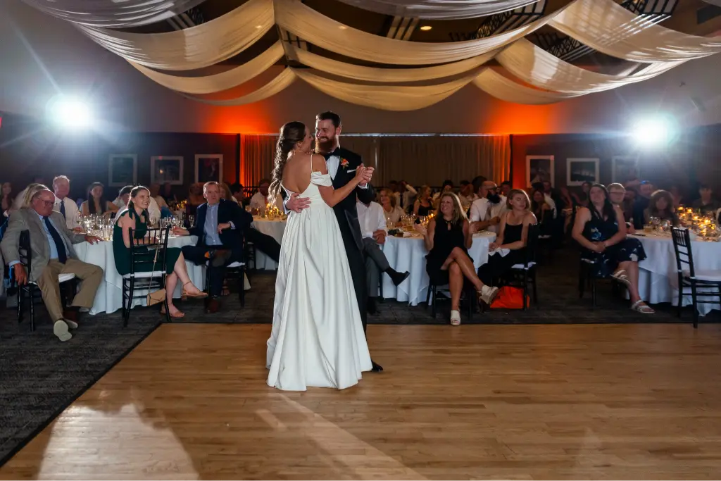 Bride and groom sharing their first dance during a Timberline Lodge wedding reception with elegant draped ceilings and romantic lighting.