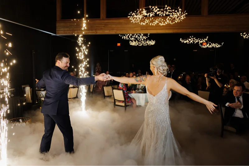 Bride and groom dancing with indoor sparklers and low-lying fog during a Black Butte Ranch wedding reception in Central Oregon.