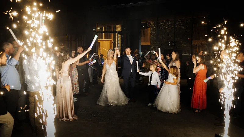 Bride and groom celebrating their grand exit with indoor sparklers during a Black Butte Ranch wedding reception in Central Oregon.