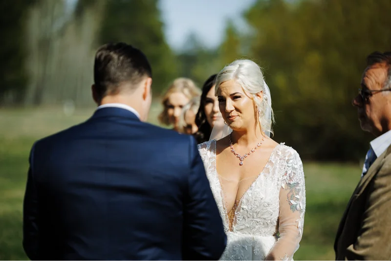 Bride and groom exchanging wedding vows during an outdoor Black Butte Ranch wedding ceremony in Central Oregon.
