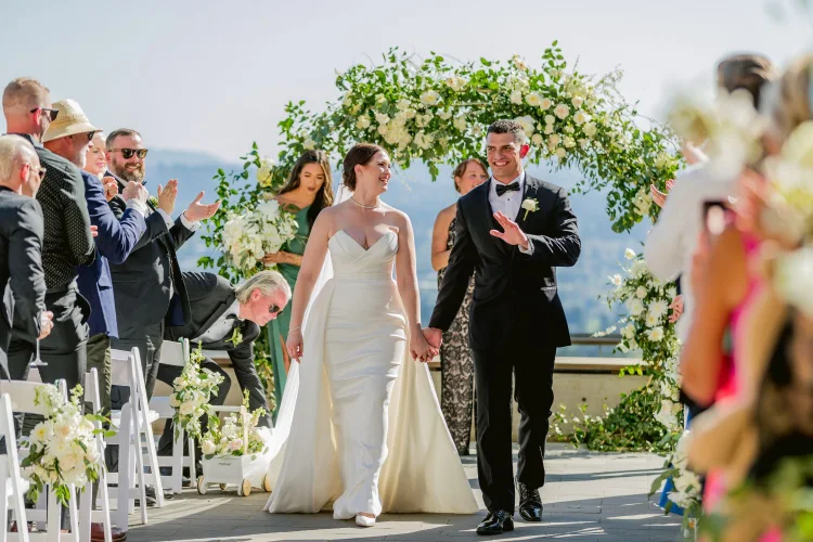 Newly married couple walking down the aisle after their Amaterra Winery wedding ceremony in Portland, Oregon.