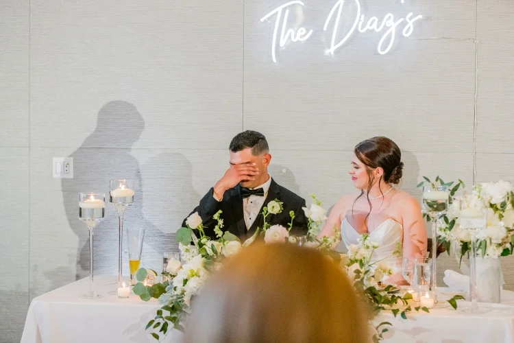 Bride and groom at the sweetheart table during an Amaterra Winery wedding reception in Portland, Oregon.