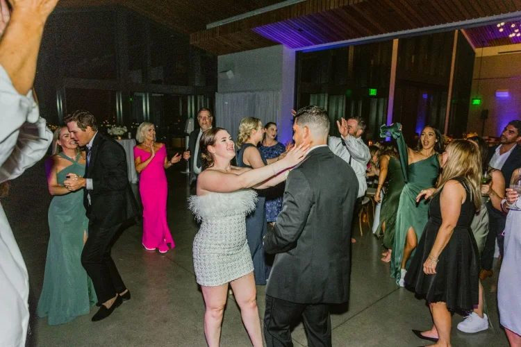 Bride and groom celebrating with guests on the dance floor during an Amaterra Winery wedding reception in Portland, Oregon.