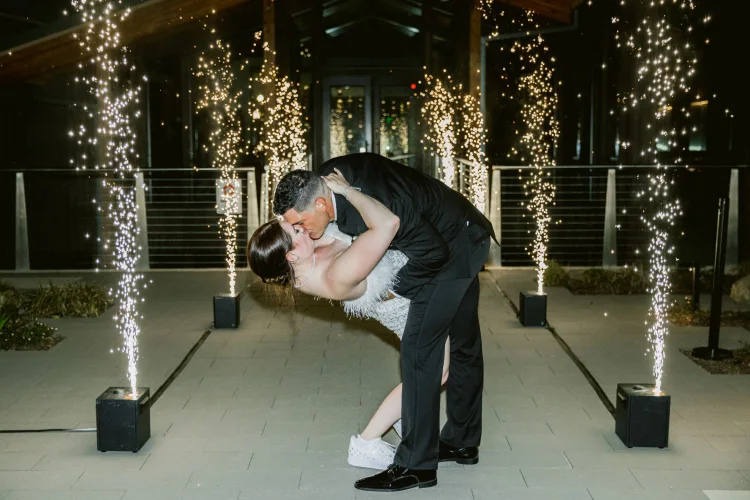 Bride and groom sharing a kiss during their sparkler exit at an Amaterra Winery wedding in Portland, Oregon.