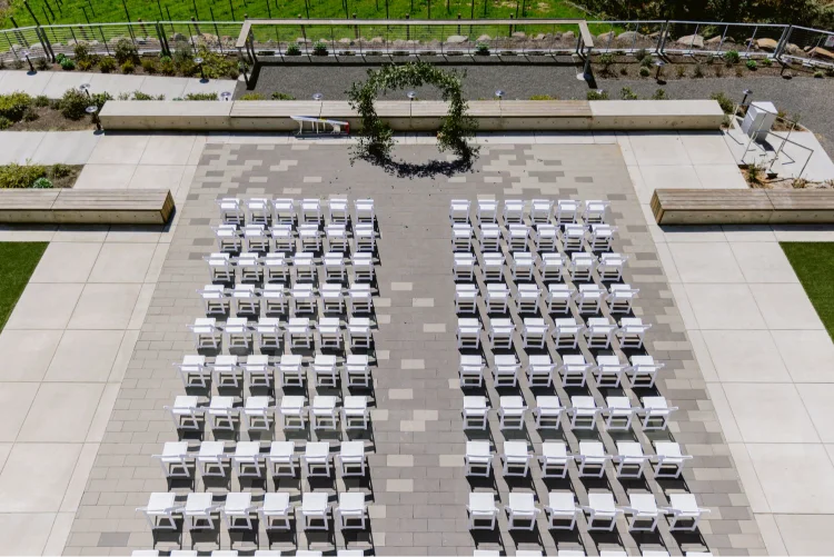 Outdoor ceremony setup with white chairs and a floral arch for an Amaterra Winery wedding in Portland, Oregon.
