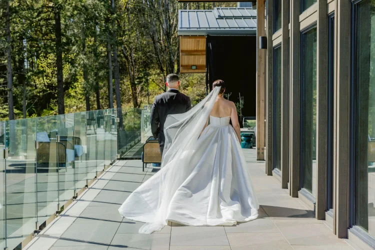Bride and groom walking along the terrace during an Amaterra Winery wedding portrait session in Portland, Oregon.