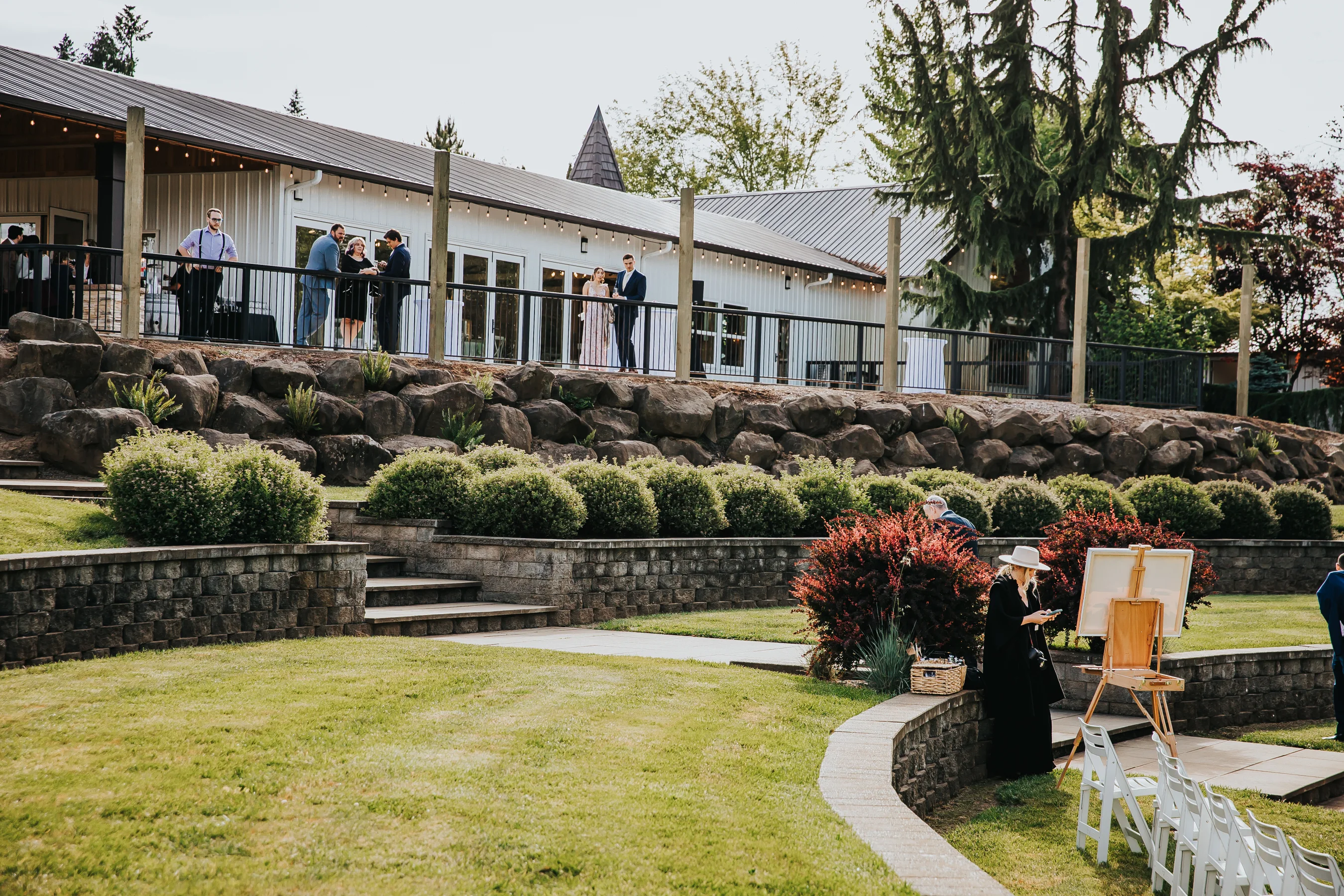Guests arriving at the outdoor ceremony space during an Aurora Vineyards wedding at Aurora Colony Vineyards in Oregon.