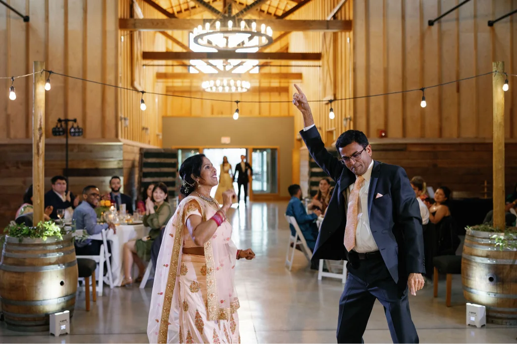 Guests dancing during a multicultural wedding reception at Abbey Road Farm in Oregon wine country.