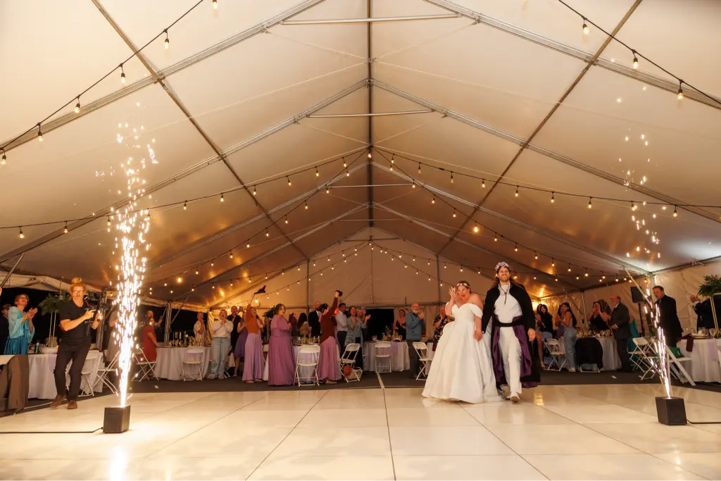 ewlyweds making their grNewlyweds making their grand entrance with indoor sparkler effects at a Camp Cedar Ridge wedding reception in Oregon.and entrance with indoor sparkler effects at a Camp Cedar Ridge wedding reception in Oregon.