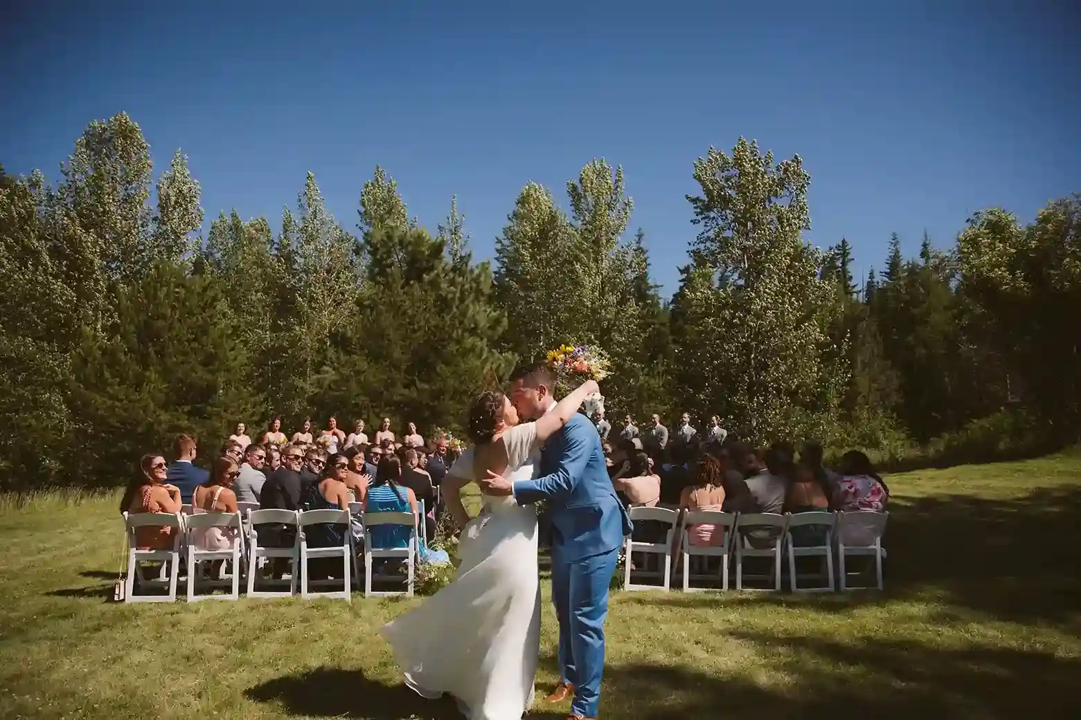 Outdoor-wedding-first-kiss-at-Cooper-Spur-Mountain-Resort-on-Mount-Hood-with-the-bride-and-groom-celebrating-after-the-ceremony.