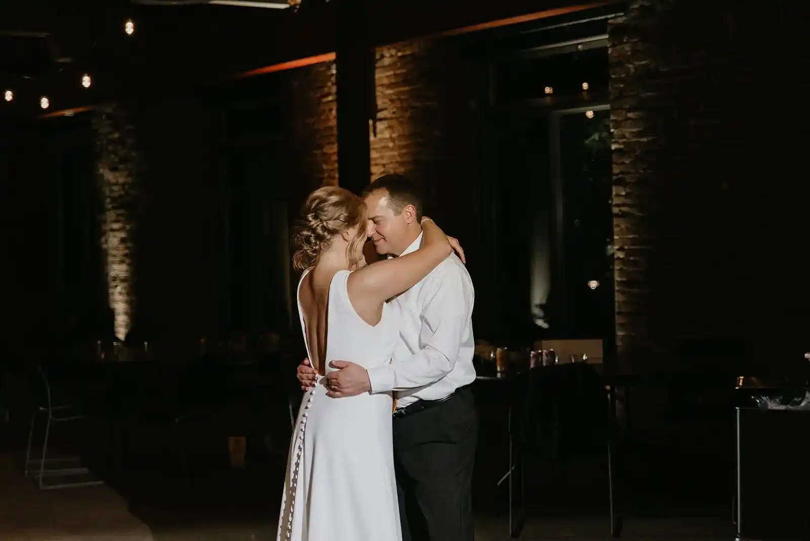 Bride-and-groom-sharing-their-first-dance-inside-the-historic-Ecotrust-Building-wedding-venue-in-Portland-Oregon.