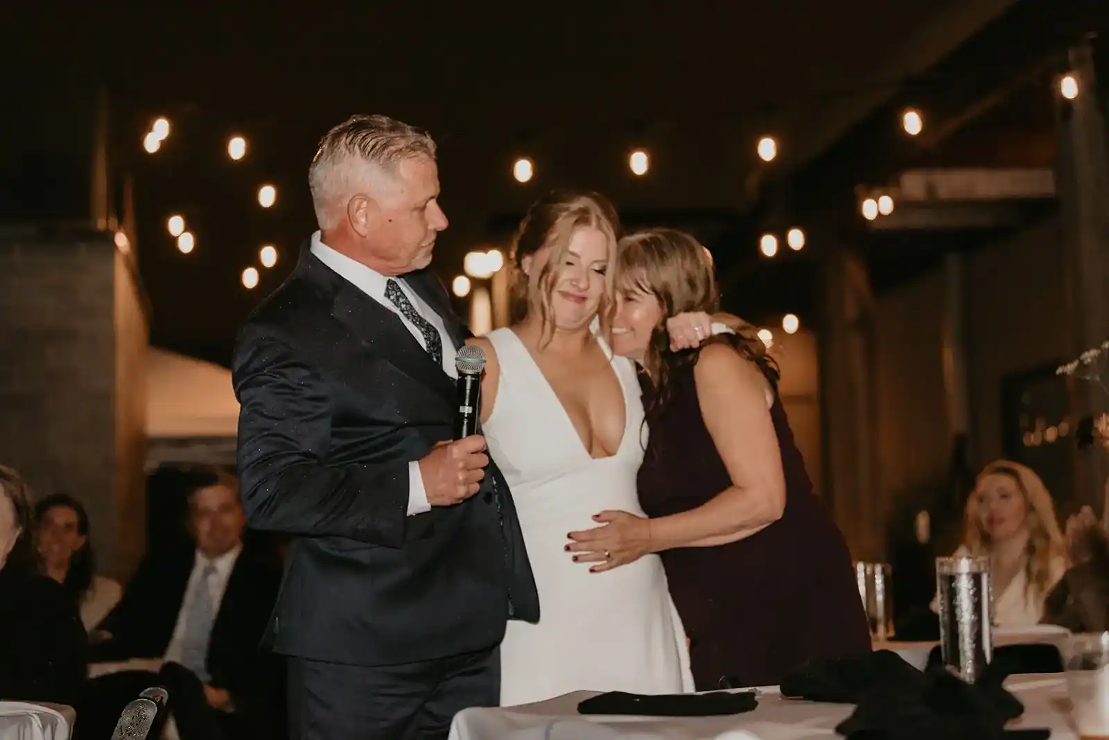 Bride-sharing-an-emotional-moment-with-family-during-a-heartfelt-wedding-reception-speech-at-the-historic-Ecotrust-Building-in-Portland-Oregon.