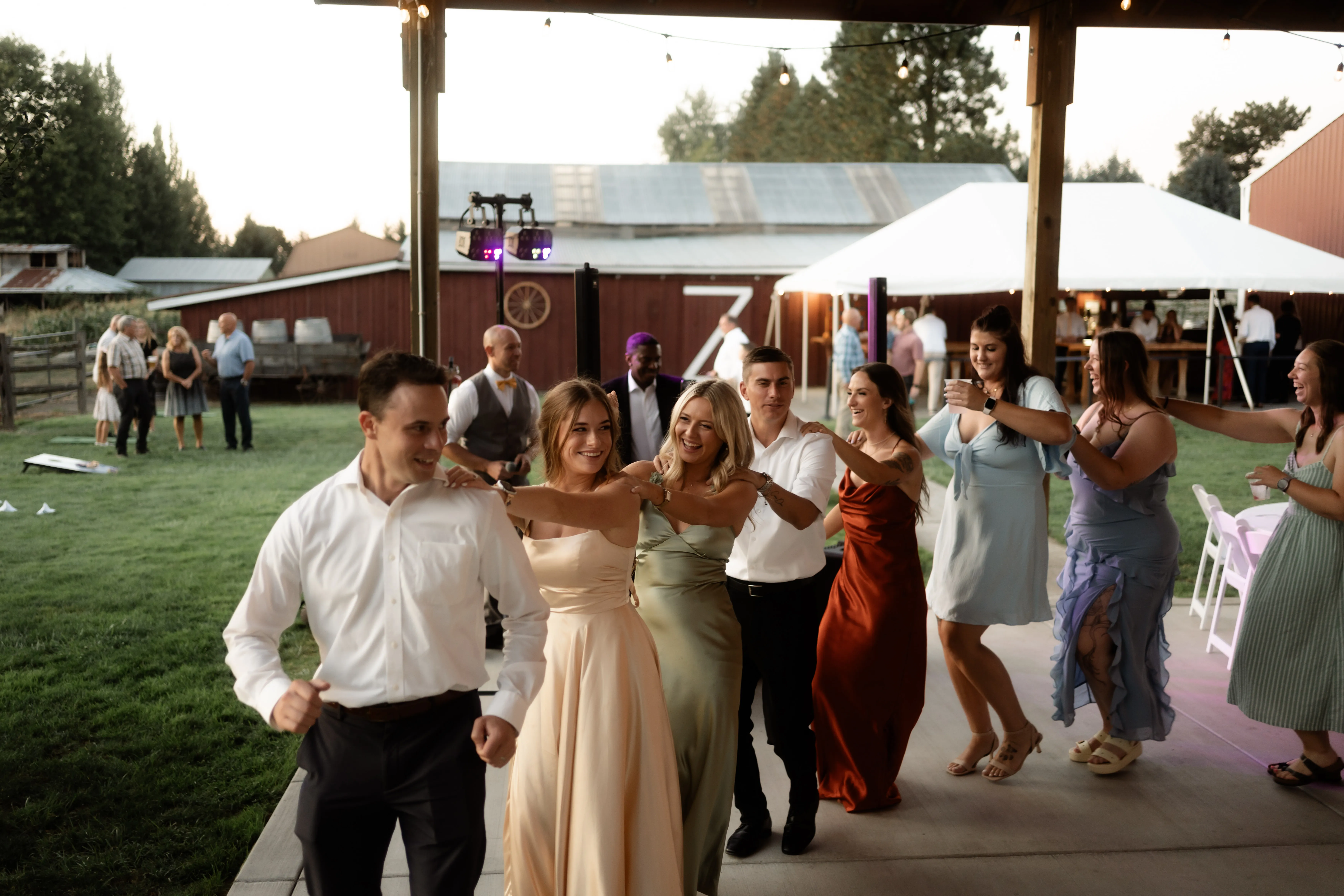 Wedding-guests-enjoying-a-lively-conga-line-during-the-reception-at-a-Jacquot-Vineyard-wedding-in-Oregon.