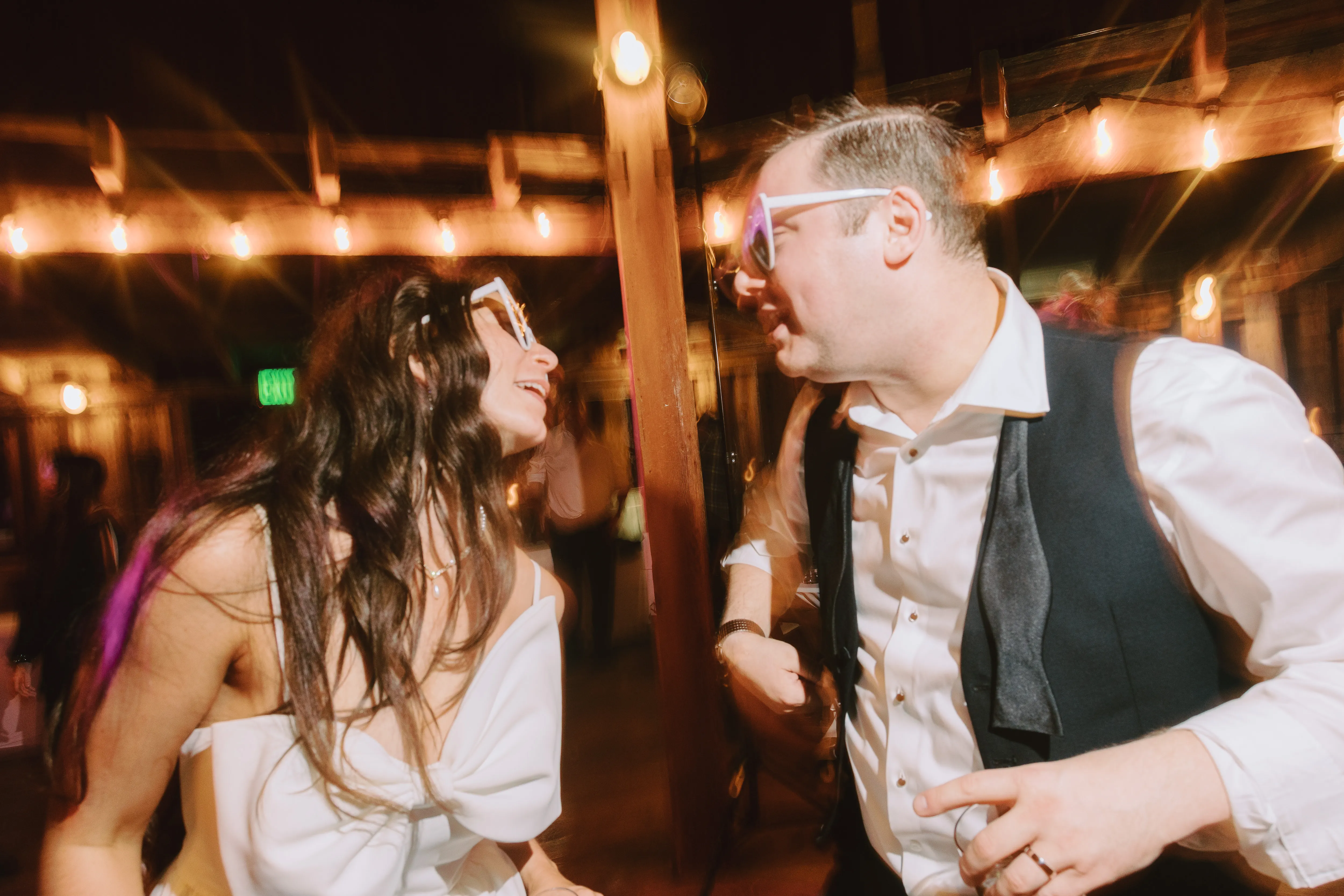 Bride-and-groom-sharing-a-fun-moment-on-the-dance-floor-during-a-Cornelius-Pass-Roadhouse-wedding-reception-in-Hillsboro-Oregon
