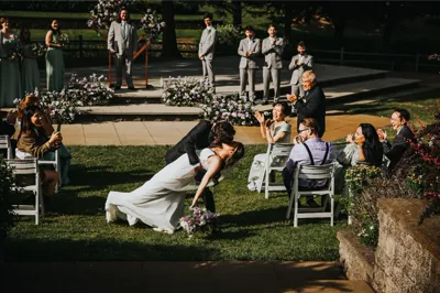 Wedding ceremony outdoors with bride and wedding party on grassy lawn