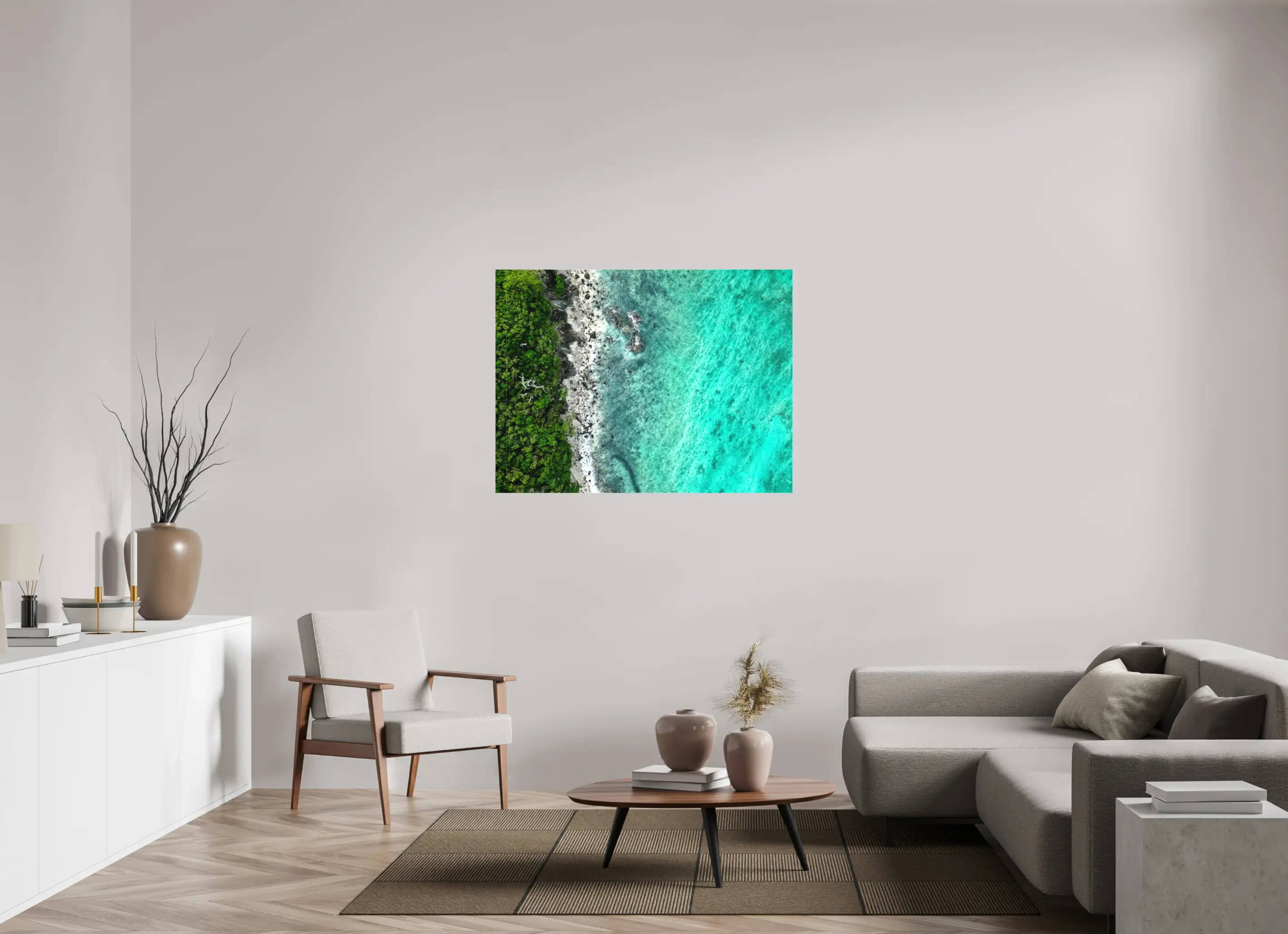 Fine art print “Tropical Jungle meets Coral Sea” featuring aerial view of lush green tropical forest meeting turquoise coral waters, displayed on a premium canvas print in a modern living room setting.