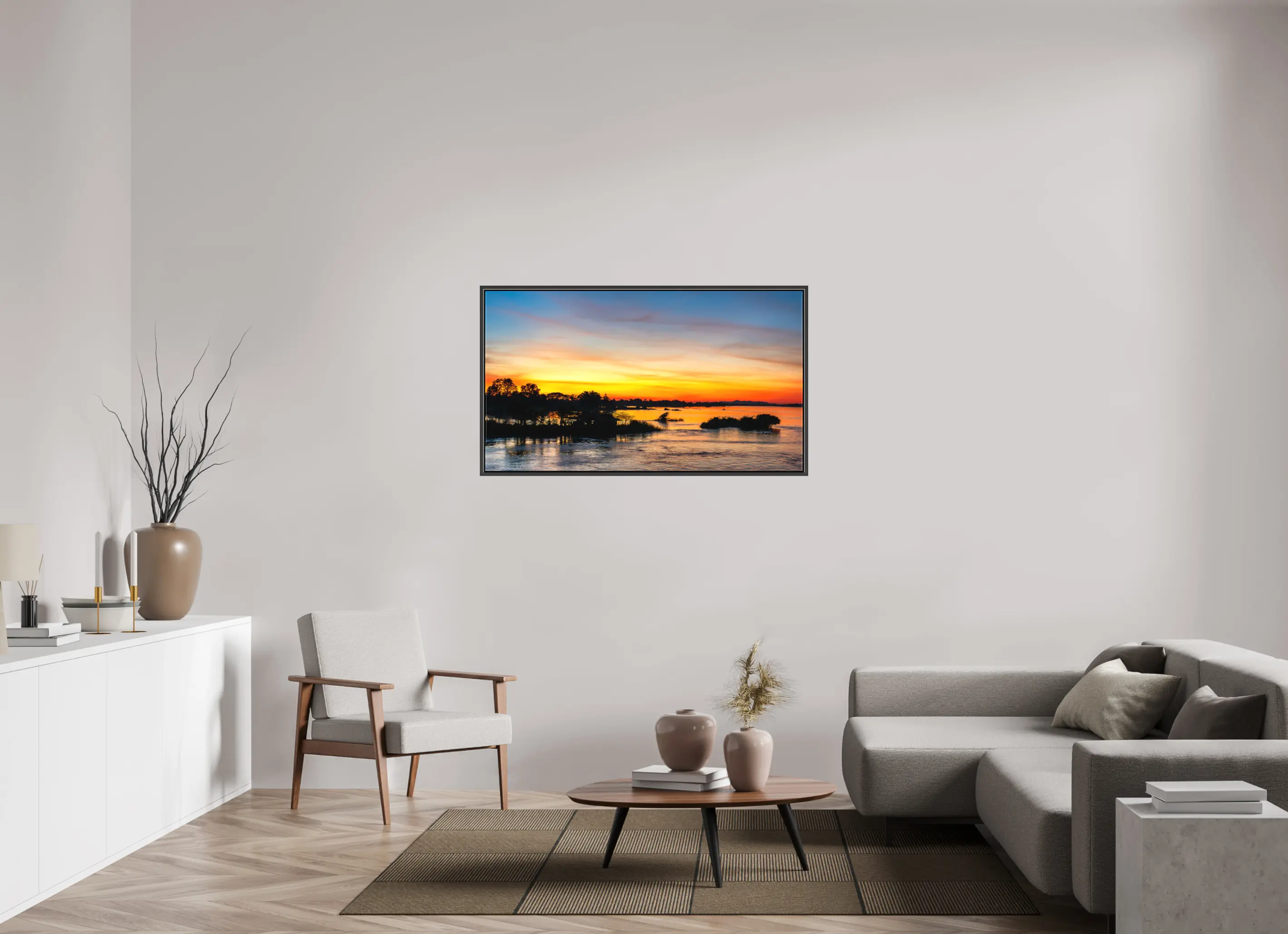 Fine art print “Fire Over the Mekong” featuring a fiery sunset with reflections of orange and gold over the Mekong River in Laos, displayed on a premium framed canvas print in a modern living room setting.