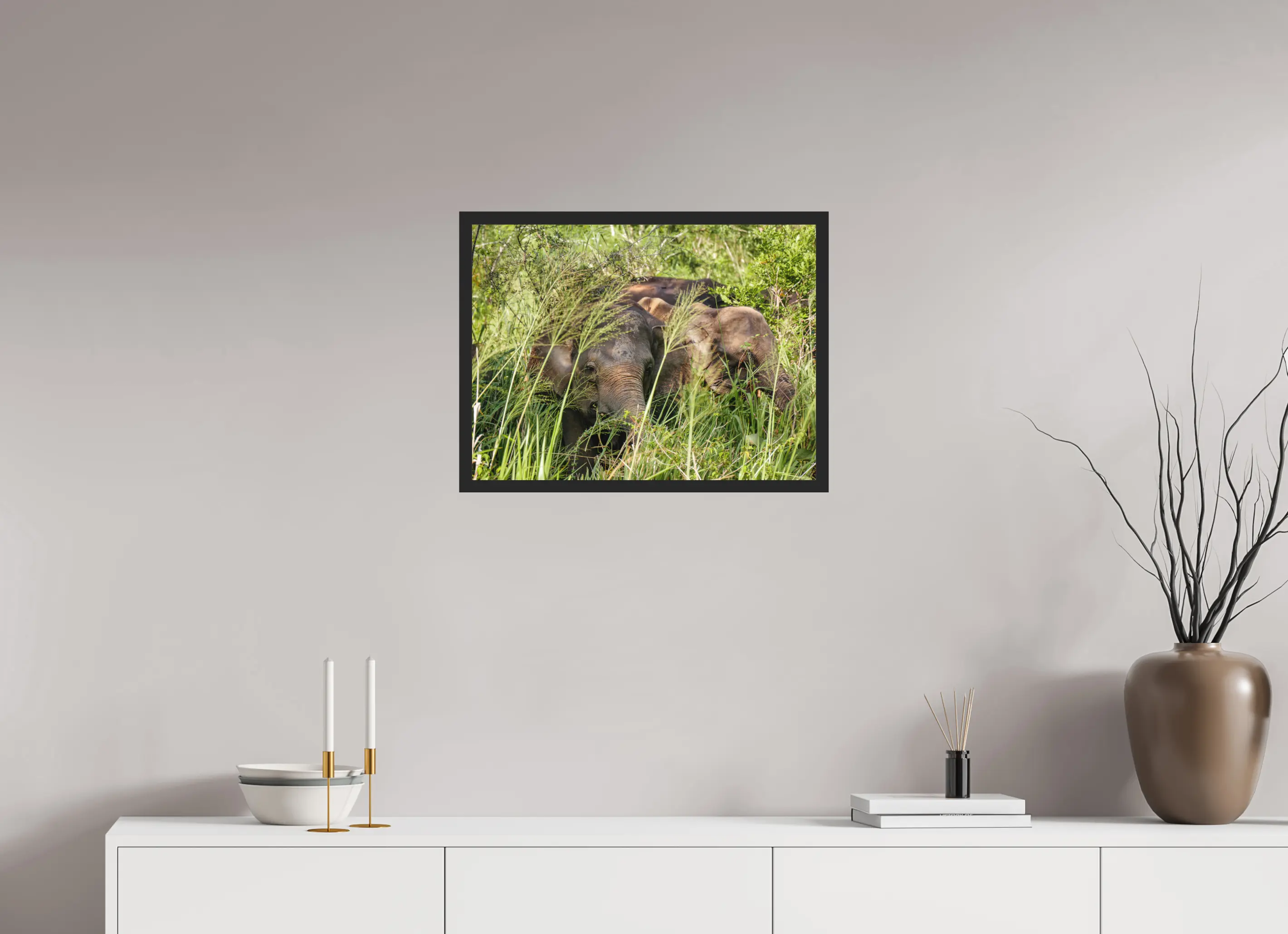 Fine art print “Gentle Giants” featuring wild asian elephants in the forests of Sri Lanka, displayed classic framed in a modern living room setting.