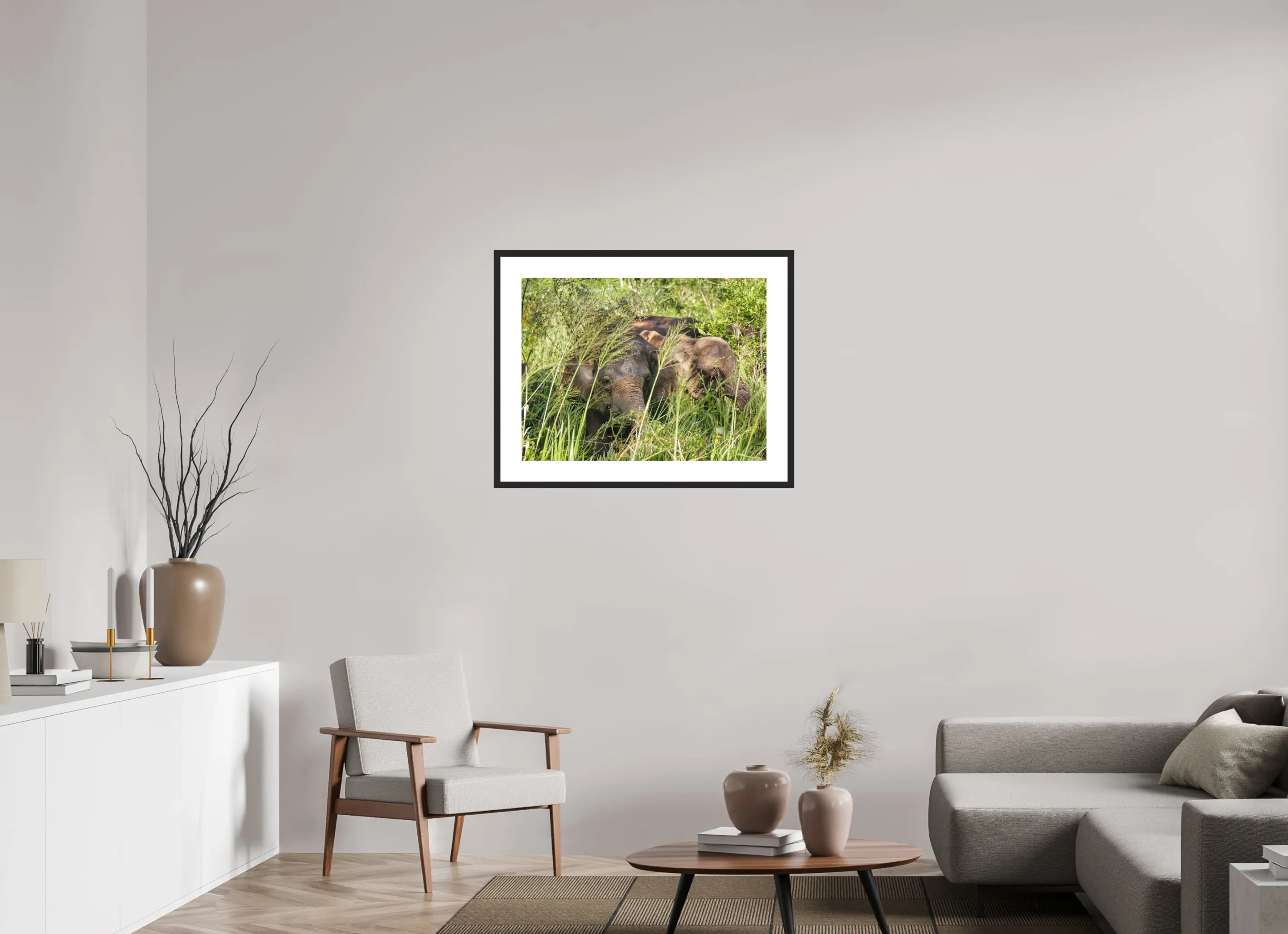 Fine art print “Gentle Giants” featuring wild asian elephants in the forests of Sri Lanka, displayed in a passepartout frame in a modern living room setting.