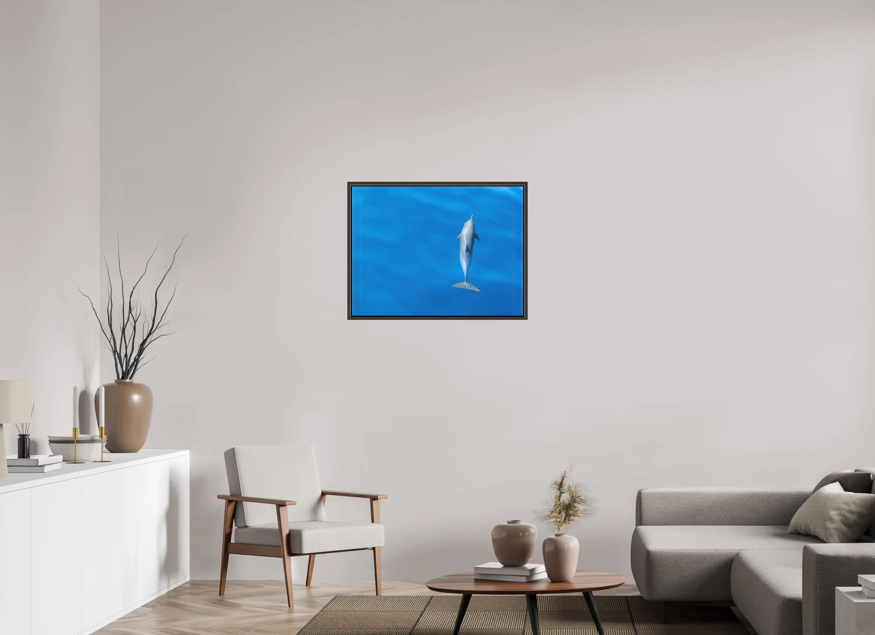 Fine art print “Grace in Blue” featuring a spinner dolphin gliding gracefully through the deep blue waters off the coast of Sri Lanka, displayed on a premium canvas print in a modern living room setting.