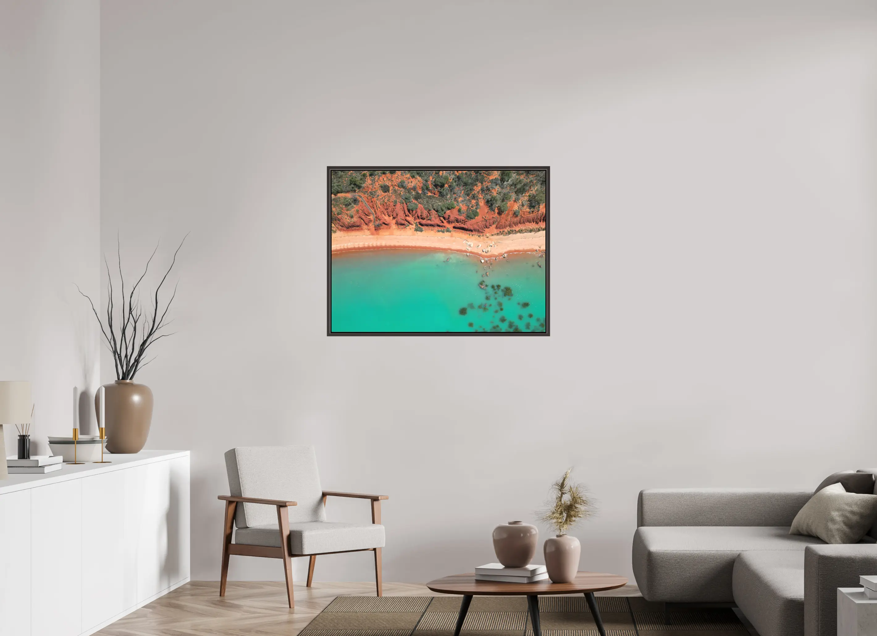 Fine art print “Painted by Nature” featuring an aerial view of red cliffs and turquoise waters meeting along the coast of Broome Western Australia, displayed on a premium framed canvas print in a modern living room setting.